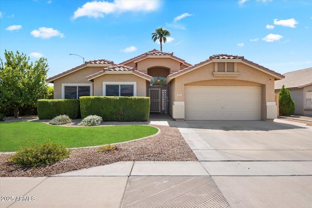 view of front facade featuring a garage, a tiled roof, concrete driveway, a front lawn, and stucco siding