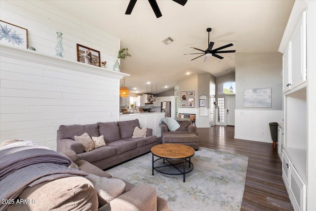 living room featuring visible vents, dark wood-style flooring, a ceiling fan, and high vaulted ceiling