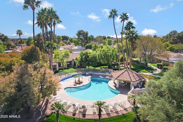 community pool with a patio, a gazebo, and fence