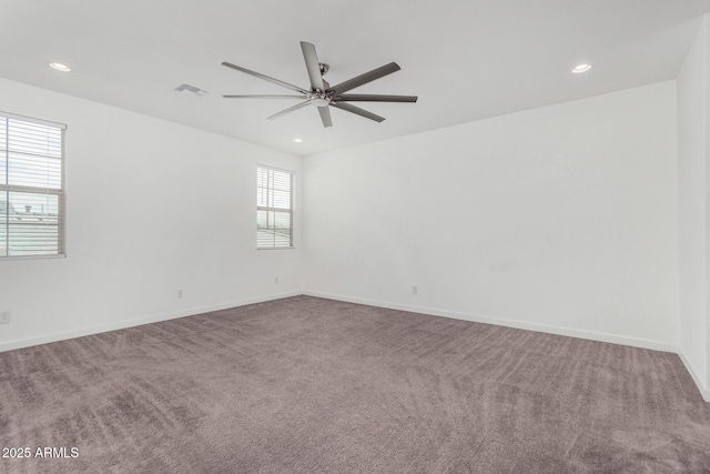 spare room featuring carpet flooring and ceiling fan