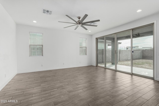 unfurnished room with ceiling fan and light wood-type flooring