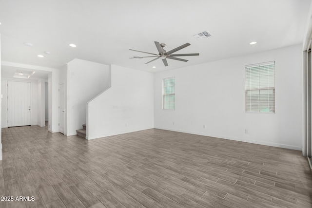 unfurnished living room with wood-type flooring and ceiling fan