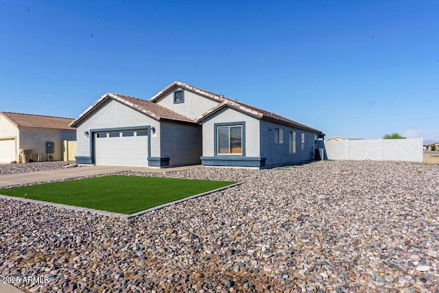 ranch-style home featuring a garage and a front yard