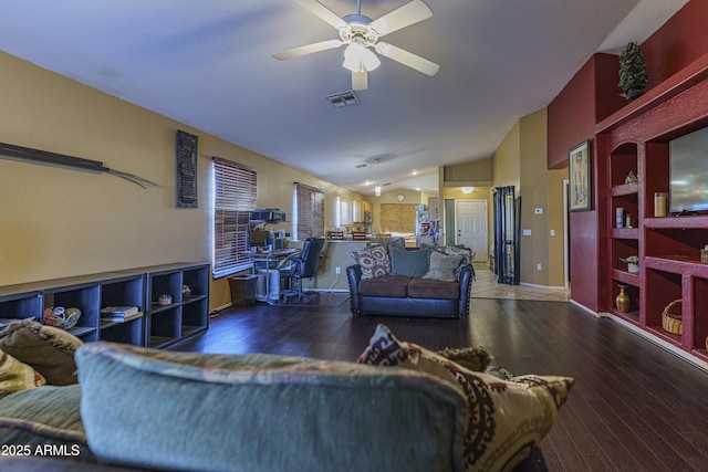 living room with ceiling fan, dark hardwood / wood-style flooring, and vaulted ceiling