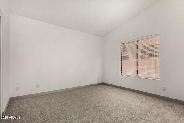 unfurnished room with baseboards, carpet floors, and vaulted ceiling