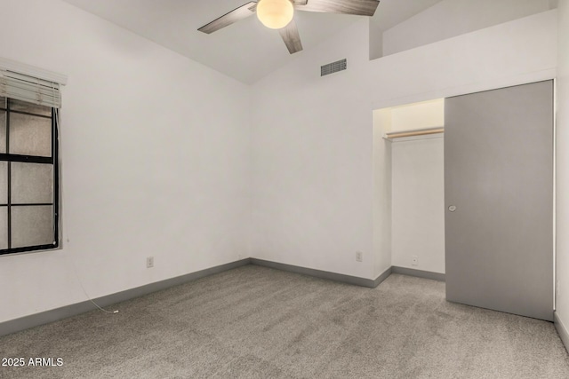 unfurnished room with visible vents, a ceiling fan, carpet, baseboards, and vaulted ceiling