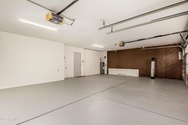 garage with electric water heater and a garage door opener