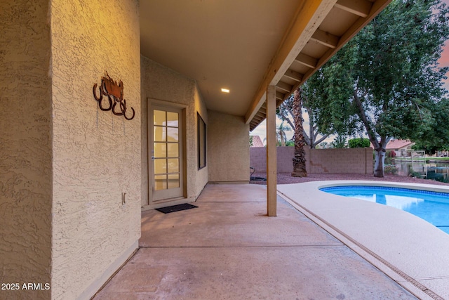 view of pool with a fenced in pool, a fenced backyard, and a patio area