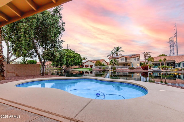 pool with a patio and fence