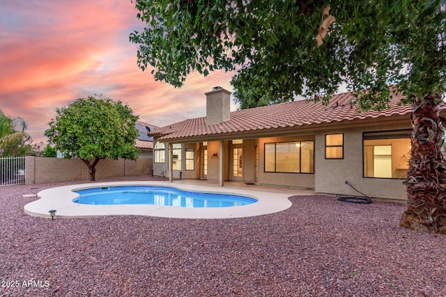 view of swimming pool featuring a fenced in pool, a patio, and fence