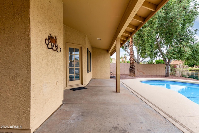 view of swimming pool featuring a fenced backyard, a fenced in pool, and a patio