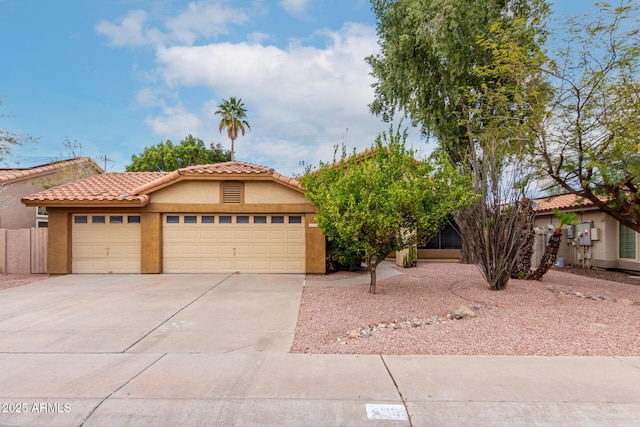 view of front of property featuring stucco siding, concrete driveway, an attached garage, and a tile roof