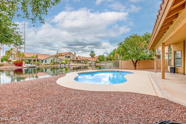 view of pool with a fenced in pool, a fenced backyard, a water view, a patio area, and a residential view