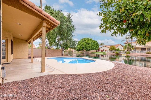 view of pool featuring a fenced in pool, a patio, a fenced backyard, and a water view