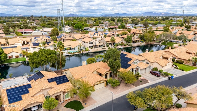 drone / aerial view with a residential view and a water view