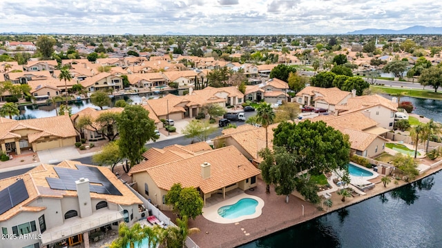 drone / aerial view featuring a residential view and a water view