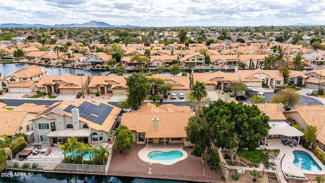 drone / aerial view featuring a residential view and a water view