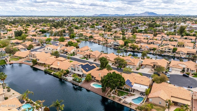 drone / aerial view featuring a residential view and a water view