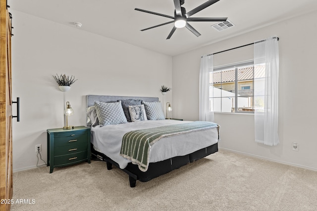 bedroom with ceiling fan and light carpet