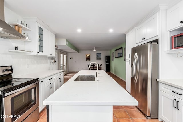 kitchen featuring white cabinets, an island with sink, and stainless steel appliances