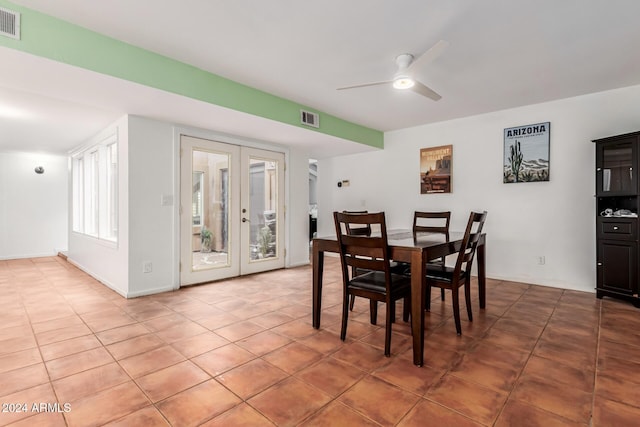 dining area with ceiling fan, french doors, and tile patterned flooring