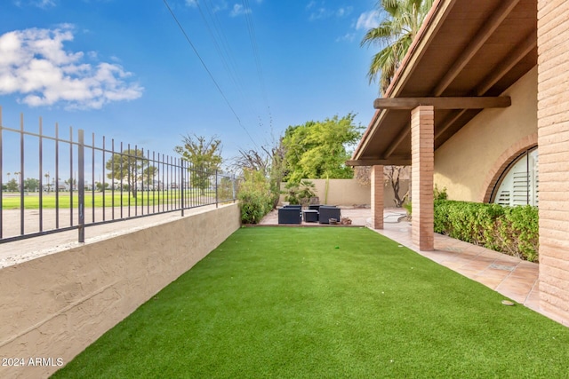 view of yard with central AC unit and a patio area