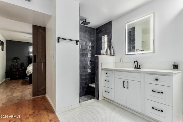 bathroom with vanity, hardwood / wood-style flooring, and walk in shower