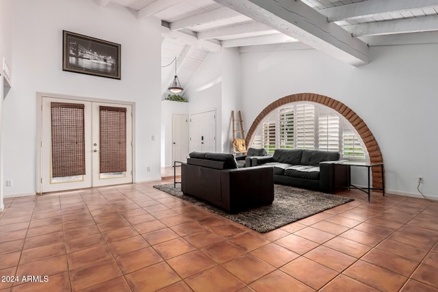 living room with vaulted ceiling with beams, tile patterned flooring, and french doors