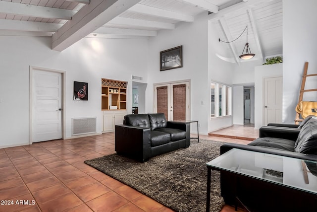 tiled living room with french doors, beamed ceiling, wood ceiling, and high vaulted ceiling