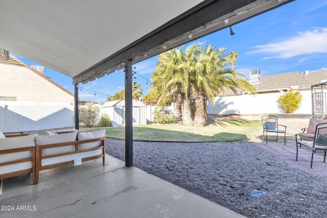 view of patio / terrace featuring an outdoor hangout area and a shed