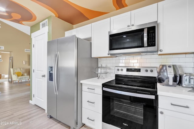 kitchen featuring decorative backsplash, white cabinetry, light hardwood / wood-style flooring, and stainless steel appliances