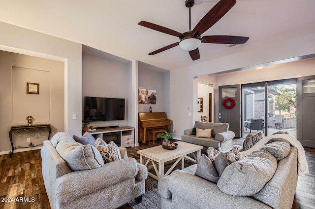 living room with dark hardwood / wood-style floors and ceiling fan