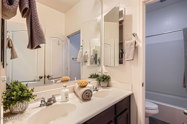 full bathroom featuring shower / bathing tub combination, vanity, and toilet