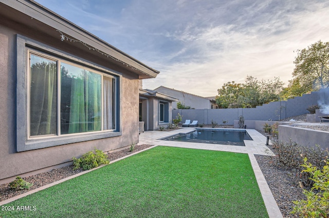 view of yard featuring a fenced in pool and a patio area