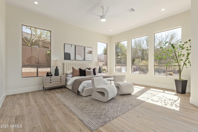 bedroom featuring ceiling fan, recessed lighting, wood finished floors, visible vents, and baseboards