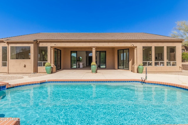 pool featuring a patio area and a sunroom