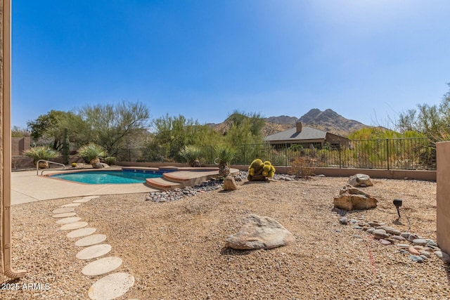 view of yard with fence, a mountain view, a fenced in pool, and a patio