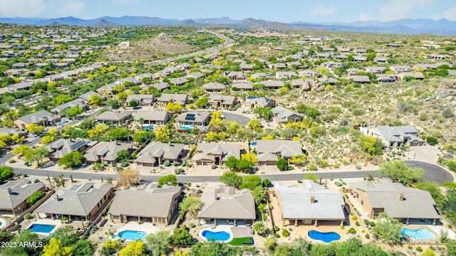 drone / aerial view featuring a residential view and a mountain view