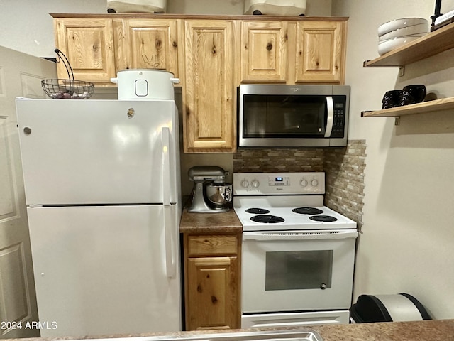 kitchen with light brown cabinets, white appliances, and backsplash