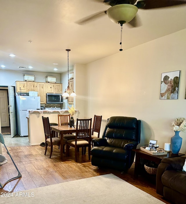 living area with light wood-style floors, ceiling fan, and recessed lighting