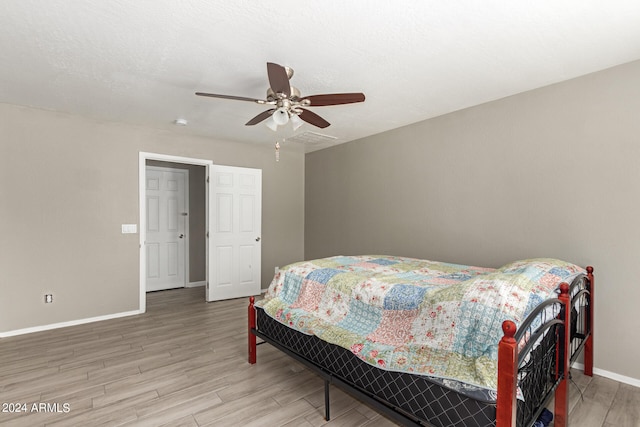 bedroom featuring wood-type flooring and ceiling fan