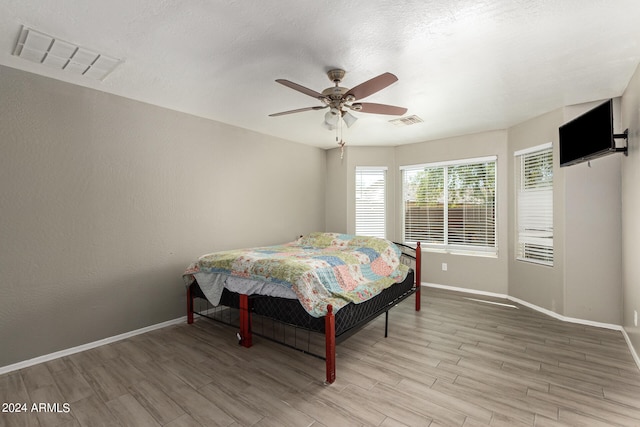 bedroom with ceiling fan and hardwood / wood-style floors