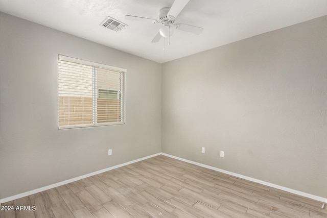 empty room with ceiling fan and light wood-type flooring