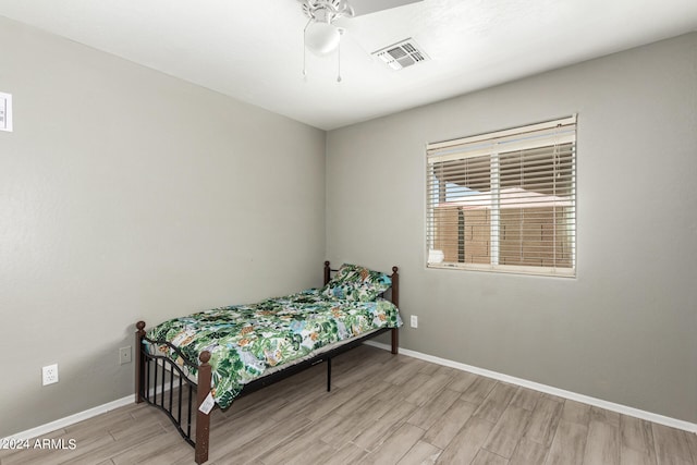 bedroom with light hardwood / wood-style floors and ceiling fan