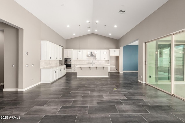 13850 W Weaver Ct, Litchfield Park, AZ 85340 - kitchen with exhaust hood, white cabinets, light countertops, a breakfast bar area, and a sink