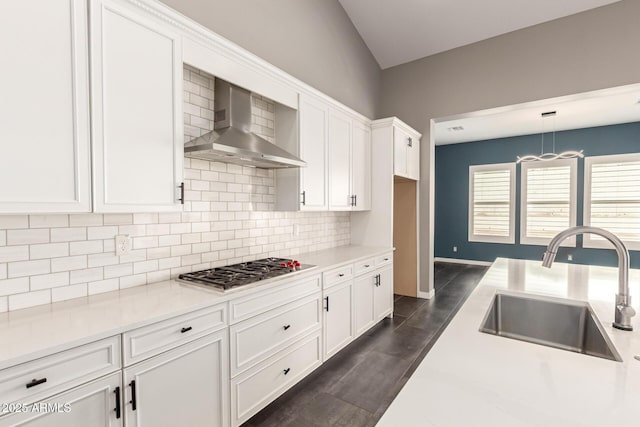 13850 W Weaver Ct, Litchfield Park, AZ 85340 - kitchen featuring wall chimney range hood, a sink, stainless steel gas stovetop, white cabinets, and tasteful backsplash