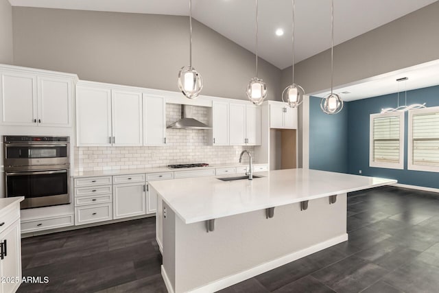 13850 W Weaver Ct, Litchfield Park, AZ 85340 - kitchen featuring a sink, wall chimney range hood, gas cooktop, high vaulted ceiling, and decorative backsplash