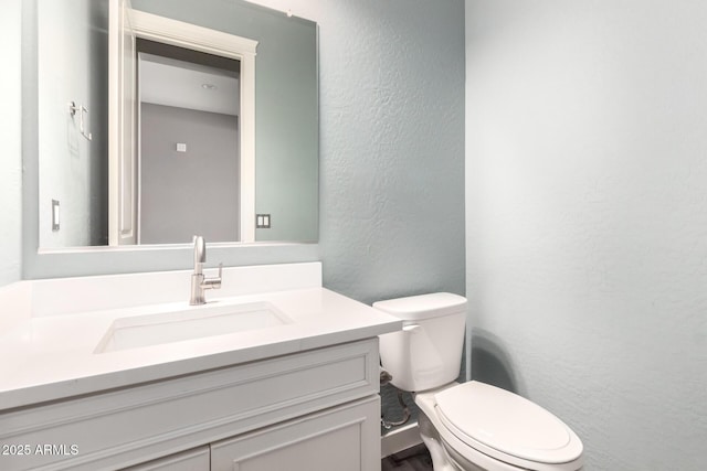 13850 W Weaver Ct, Litchfield Park, AZ 85340 - bathroom with a textured wall, vanity, and toilet