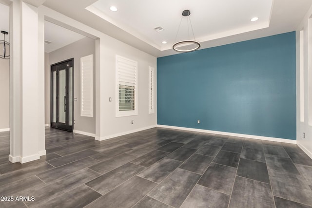13850 W Weaver Ct, Litchfield Park, AZ 85340 - empty room with a raised ceiling, recessed lighting, baseboards, and wood finished floors