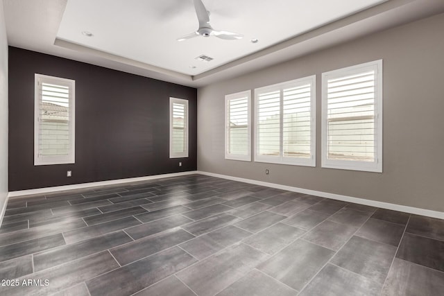 13850 W Weaver Ct, Litchfield Park, AZ 85340 - unfurnished room featuring a raised ceiling, ceiling fan, and baseboards